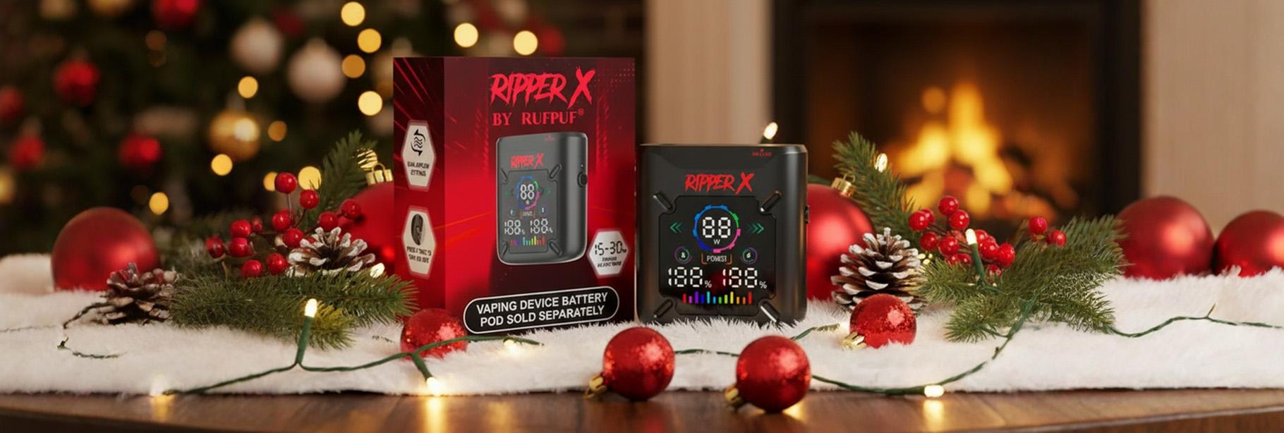 Two Ripper X vape devices on a festive surface with Christmas decorations and a fireplace in the background.
